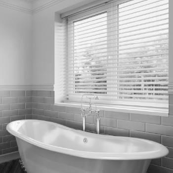 Wooden venetian blind fitted to window above kitchen sink